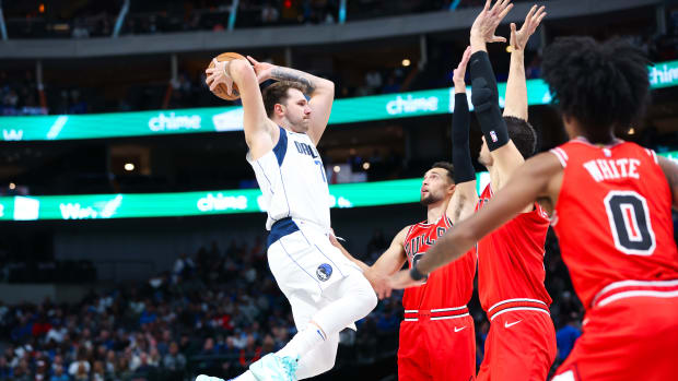 Dallas Mavericks superstar Luka Doncic takes flight as three Chicago Bulls look on.